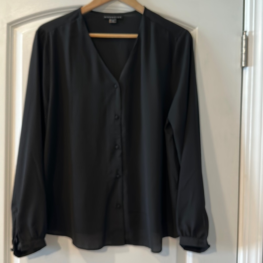 Black blouse. Never worn. Without tags. Long sleeve with buttons.100% Polyester